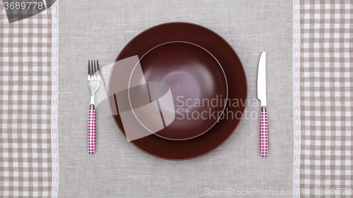 Image of empty plate with fork and knife