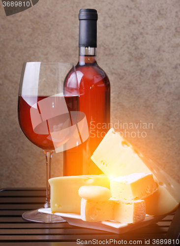 Image of wineglass, bottle of wine cheese