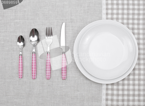 Image of empty plate with fork, spoon and knife