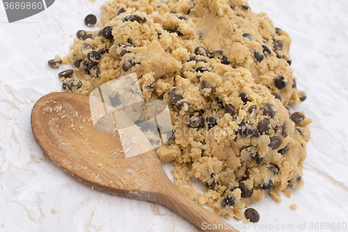 Image of Wooden spoon with chocolate chip cookie dough