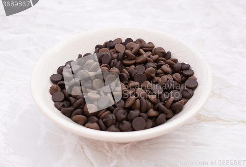 Image of Dish of milk and dark chocolate chips