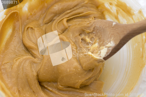 Image of Peanut butter and butter with a wooden spoon