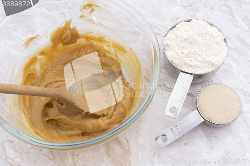 Image of Cups of flour and sugar with peanut butter mixture