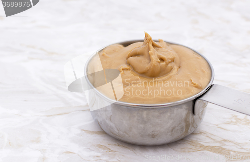 Image of Peanut butter in a measuring cup