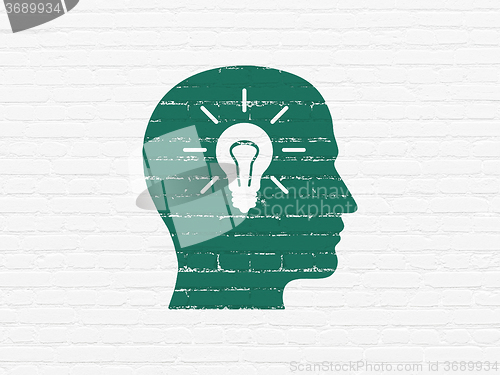 Image of Marketing concept: Head With Light Bulb on wall background