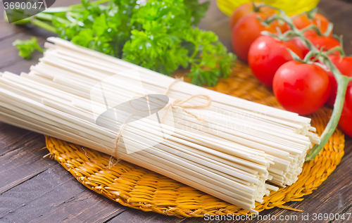 Image of raw pasta and  tomato and sauce