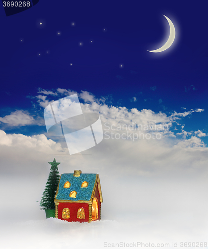 Image of Christmas festive light in house under blue sky