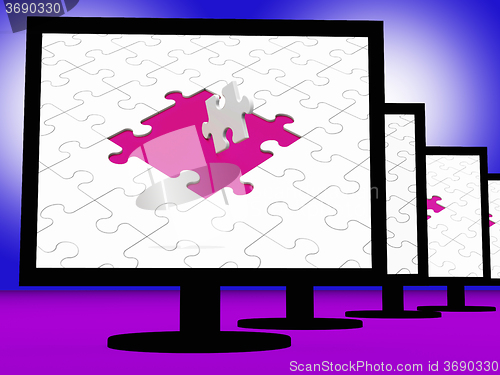 Image of Unfinished Puzzle On Monitors Showing Completion