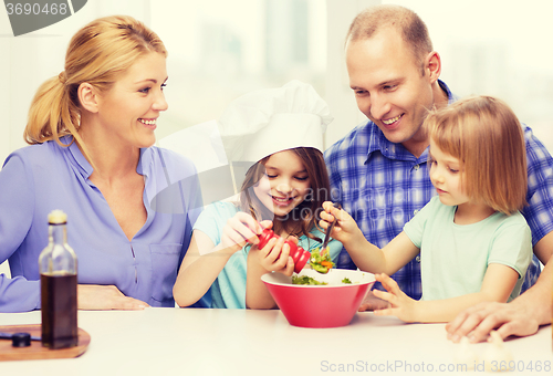 Image of happy family with two kids making dinner at home