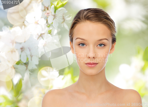 Image of young woman face over cherry blossoms