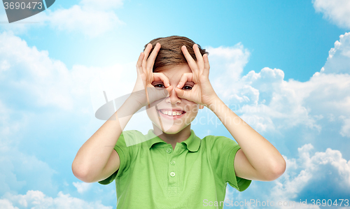 Image of happy boy in t-shirt having fun and making faces