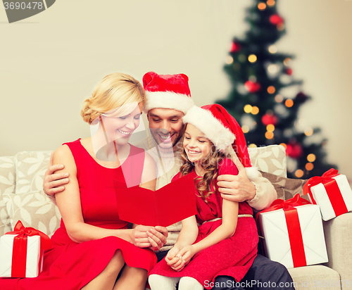 Image of smiling family reading postcard