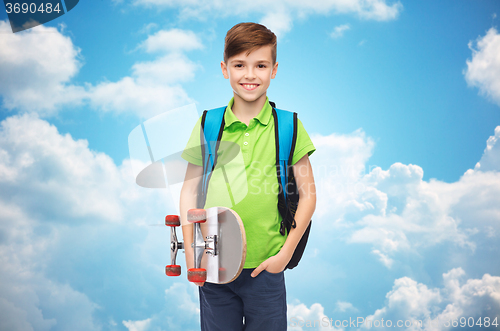 Image of happy student boy with backpack and skateboard