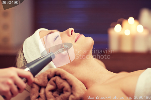 Image of close up of young woman having face massage in spa