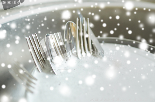 Image of close up of dirty dishes washing in kitchen sink