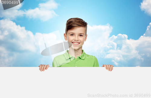 Image of happy boy in t-shirt holding white blank board