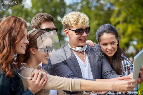 Image of students or teenagers with tablet pc taking selfie