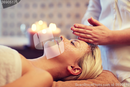 Image of close up of woman having face massage in spa