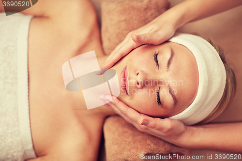 Image of close up of young woman having face massage in spa