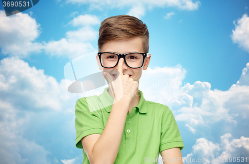 Image of happy boy in green polo t-shirt and eyeglasses