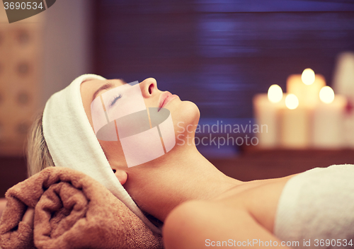 Image of close up of young woman lying in spa