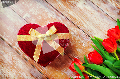 Image of close up of red tulips and chocolate box