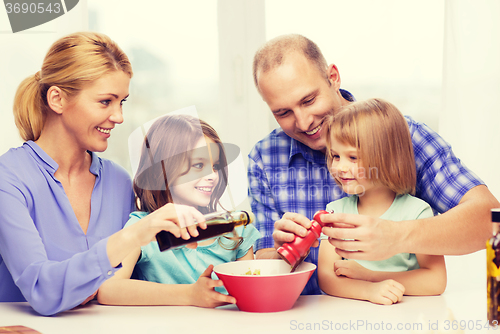 Image of happy family with two kids making dinner at home