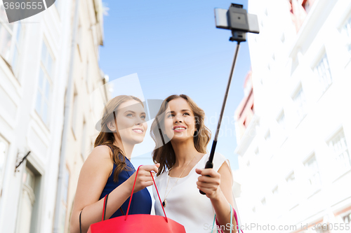 Image of women shopping and taking selfie by smartphone