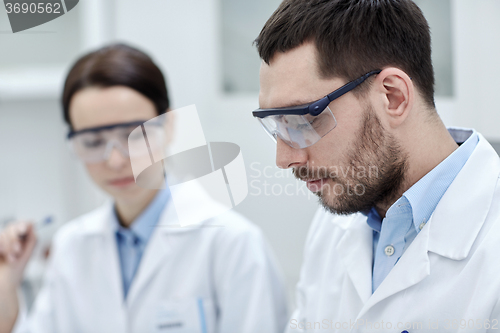 Image of close up of young scientists at laboratory