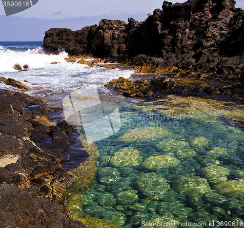 Image of cloudy  beach    water   lanzarote  isle   rock spain   stone sk