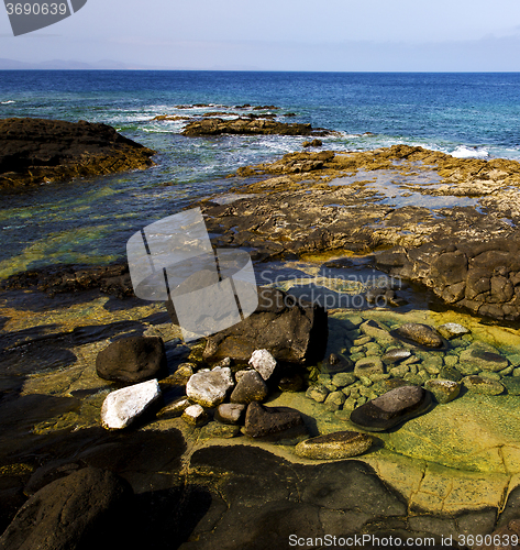 Image of rock stone sky cloud beach  water  coastline  in lanzarote spain