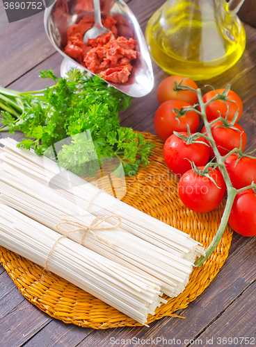 Image of raw pasta and  tomato and sauce