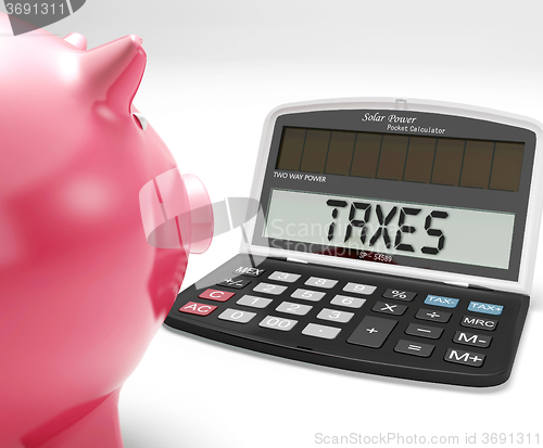 Image of Taxes On Calculator Shows Income Tax Return