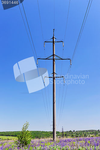 Image of High-voltage electric pole with wires on a background of blue sk