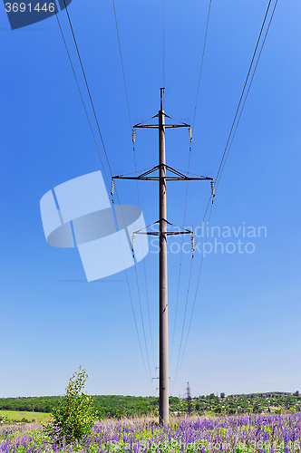 Image of High-voltage electric pole with wires on a background of blue sk