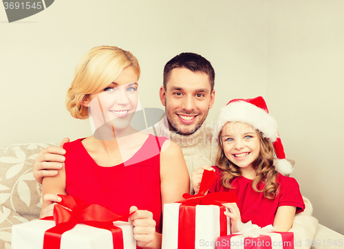 Image of smiling family holding many gift boxes