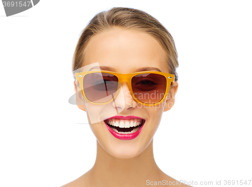 Image of happy young woman in sunglasses with pink lipstick