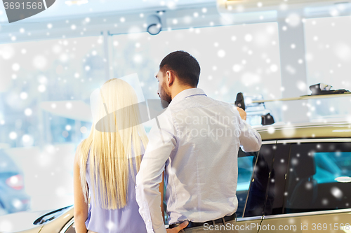 Image of couple choosing car in auto show or salon