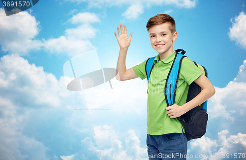 Image of happy student boy with school bag waving hand