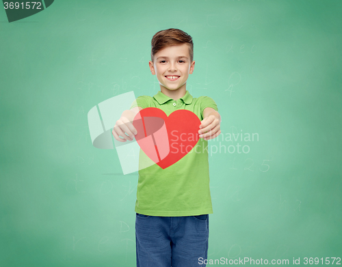 Image of happy school boy holding red heart shape