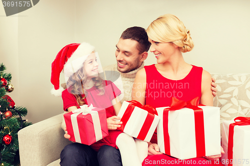 Image of smiling family holding many gift boxes