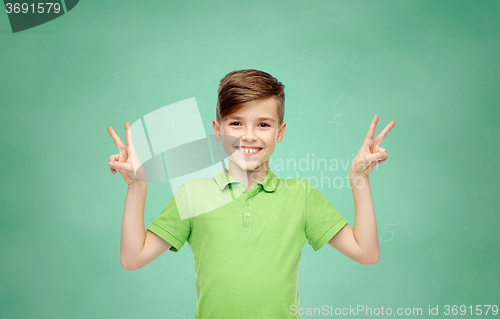 Image of school boy showing peace or victory hand sign