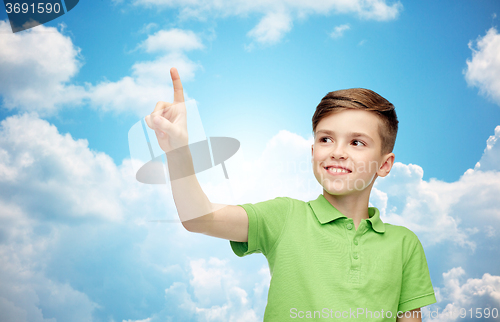 Image of happy boy in green polo t-shirt pointing finger up