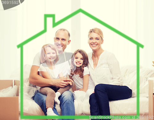 Image of smiling parents and two little girls at new home