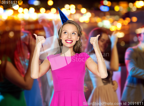 Image of happy young woman or teen girl in party hat