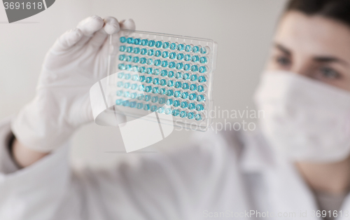 Image of close up of scientist making test in lab