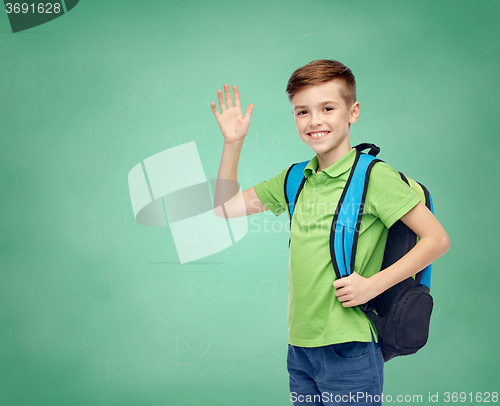 Image of happy student boy with school bag waving hand
