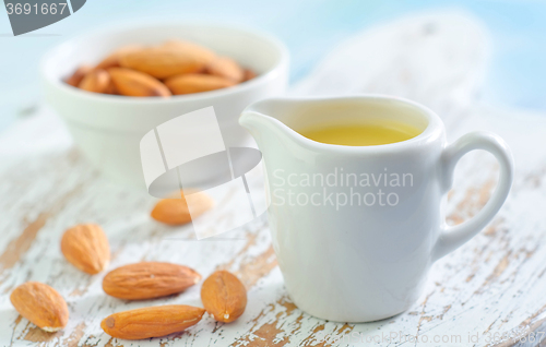 Image of almond essential oil and almond in bowl