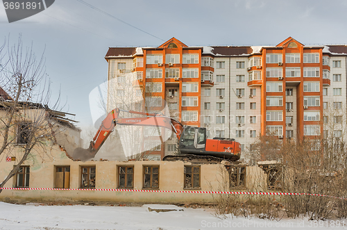 Image of A digger demolishing houses for reconstruction