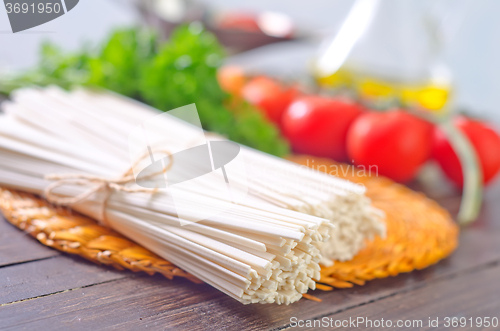 Image of raw pasta and  tomato and sauce